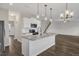 Spacious kitchen featuring stainless steel appliances, white cabinetry, and an island at 8 Looping Horse Cir, Angier, NC 27501
