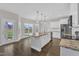 A kitchen boasts stainless steel appliances, a granite island, and a white cabinet at 8 Looping Horse Cir, Angier, NC 27501