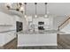 Kitchen island with granite countertop in an open kitchen with stainless steel appliances at 8 Looping Horse Cir, Angier, NC 27501
