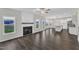 Open concept living room with fireplace, hardwood floors, and connecting kitchen area at 8 Looping Horse Cir, Angier, NC 27501