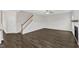 Spacious living room featuring dark wood floors, stairway, a ceiling fan, and fireplace at 8 Looping Horse Cir, Angier, NC 27501
