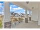View from covered porch with stone-base columns, concrete floor and view of neighborhood at 8 Looping Horse Cir, Angier, NC 27501