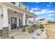 Up close image of front porch featuring stone-base columns, concrete floor and white exterior at 8 Looping Horse Cir, Angier, NC 27501