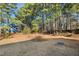 Large backyard with mature trees and a grassy area at 808 Kinsman Ct, Raleigh, NC 27603