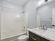 Bathroom with single vanity, shower/tub combo, and dark cabinetry at 808 Kinsman Ct, Raleigh, NC 27603