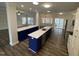 Spacious kitchen featuring a large island with quartz countertops and blue cabinetry at 808 Kinsman Ct, Raleigh, NC 27603