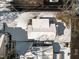 Aerial view of a snow-covered home and yard in a quiet neighborhood on a sunny day in winter at 819 Cumberland St, Raleigh, NC 27610