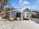 Backyard of a home with blue siding, snow, and a wooden deck at 819 Cumberland St, Raleigh, NC 27610