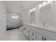 Modern bathroom featuring double vanity, marble tile flooring, and a glass shower at 819 Cumberland St, Raleigh, NC 27610