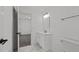 Bathroom with white vanity, mirror, and toilet, with marble flooring and a view to bedroom at 819 Cumberland St, Raleigh, NC 27610