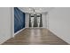 Bedroom with dark blue accent wall and hardwood floors at 819 Cumberland St, Raleigh, NC 27610