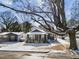 Quaint home with covered porch, set amongst mature trees, and a detached garage at 819 Cumberland St, Raleigh, NC 27610