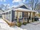Charming home featuring a covered front porch, snow accents, and modern design at 819 Cumberland St, Raleigh, NC 27610