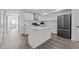 Bright kitchen features white cabinets, stainless steel appliances, an island, and modern finishes at 819 Cumberland St, Raleigh, NC 27610