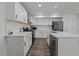 Updated kitchen featuring white cabinets, stainless steel appliances, and modern countertops at 819 Cumberland St, Raleigh, NC 27610