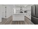 Modern kitchen with white cabinets, stainless steel appliances, and a central island at 819 Cumberland St, Raleigh, NC 27610