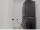 The laundry room features a stackable washer and dryer and patterned tile floor at 819 Cumberland St, Raleigh, NC 27610