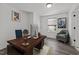 Home office with a wood desk, comfortable seating, and natural light from the window at 819 Cumberland St, Raleigh, NC 27610
