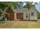 View of home's backyard featuring a brick section and a white siding section under a clear sky at 945 Sycamore St, Rocky Mount, NC 27801