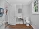 Bathroom with toilet and sink, including a mirror and window at 945 Sycamore St, Rocky Mount, NC 27801