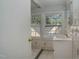 Cozy bathroom features a white sink and tiled walls, illuminated by natural light from two windows at 945 Sycamore St, Rocky Mount, NC 27801