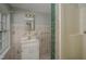 Bathroom featuring unique floral tiling, a practical vanity, and a walk-in shower at 945 Sycamore St, Rocky Mount, NC 27801