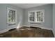 Sunlit bedroom featuring hardwood floors and large windows offering a bright and inviting space at 945 Sycamore St, Rocky Mount, NC 27801