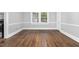 Charming dining room featuring hardwood floors, a large window, and classic trim at 945 Sycamore St, Rocky Mount, NC 27801
