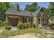 Brick house with stone accents, covered porch, and mature trees at 945 Sycamore St, Rocky Mount, NC 27801