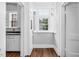 Hallway features wood floors and doors leading to other rooms and kitchen at 945 Sycamore St, Rocky Mount, NC 27801