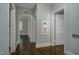 Long hallway with hardwood floors and access to bedrooms at 945 Sycamore St, Rocky Mount, NC 27801