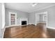 Bright living room featuring a fireplace, hardwood floors, and a glass-paneled door at 945 Sycamore St, Rocky Mount, NC 27801