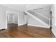 Bright room features hardwood floors, staircase, and an open doorway leading to additional spaces at 945 Sycamore St, Rocky Mount, NC 27801