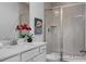 Bathroom with white vanity, frameless shower, and tiled walls at 91 Priming Way, Angier, NC 27501