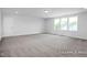 Spacious bedroom with carpeted floors and multiple windows at 91 Priming Way, Angier, NC 27501