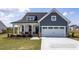 Two-story house with gray siding, white trim, and a two-car garage at 91 Priming Way, Angier, NC 27501