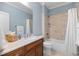 Charming bathroom features a granite vanity, warm lighting, and a tub shower combination at 101 Bonica Creek Dr, Garner, NC 27529