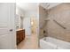 Well-lit bathroom features a shower and tub combination, a sink with a granite countertop at 101 Bonica Creek Dr, Garner, NC 27529