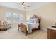 Inviting bedroom featuring large windows, a ceiling fan, and classic furniture, perfect for rest and relaxation at 101 Bonica Creek Dr, Garner, NC 27529