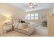 Bright bedroom features a ceiling fan, beige walls, and plush carpeting for ultimate comfort at 101 Bonica Creek Dr, Garner, NC 27529