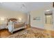 Elegant bedroom features a decorative rug, classic furnishings, and access to a spacious walk-in closet at 101 Bonica Creek Dr, Garner, NC 27529