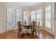 Charming breakfast nook featuring wood floors, bay windows with plantation shutters and a chandelier at 101 Bonica Creek Dr, Garner, NC 27529