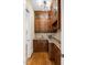 Butler's pantry featuring rich wood cabinetry, granite counters and stainless steel sink at 101 Bonica Creek Dr, Garner, NC 27529