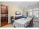 Formal dining room featuring a large table, elegant blue chairs, and a stylish chandelier at 101 Bonica Creek Dr, Garner, NC 27529