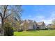 Spacious brick home with a sprawling lawn and mature trees at 101 Bonica Creek Dr, Garner, NC 27529