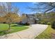 Large brick home featuring an attached garage, long driveway, and well-maintained landscaping at 101 Bonica Creek Dr, Garner, NC 27529