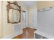 Inviting foyer with hardwood floors, decorative mirror, and convenient bench seating at 101 Bonica Creek Dr, Garner, NC 27529