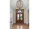 Elegant front entrance featuring a stunning double door with decorative ironwork and a modern chandelier at 101 Bonica Creek Dr, Garner, NC 27529