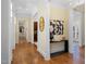 Bright hallway featuring hardwood floors, classic white trim, and decorative accents at 101 Bonica Creek Dr, Garner, NC 27529