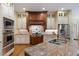 Gourmet kitchen featuring custom cabinetry, granite countertops, and stainless steel appliances at 101 Bonica Creek Dr, Garner, NC 27529